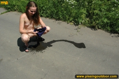 Teen girl pissing on asphalt outdoor - N