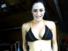 A teen girl flashing in garage in front of workers